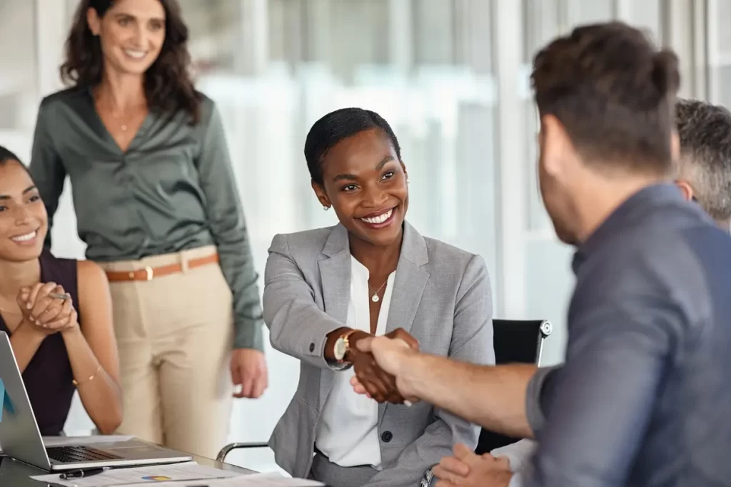 Empresária negra madura apertando a mão de novo parceiro de negócios